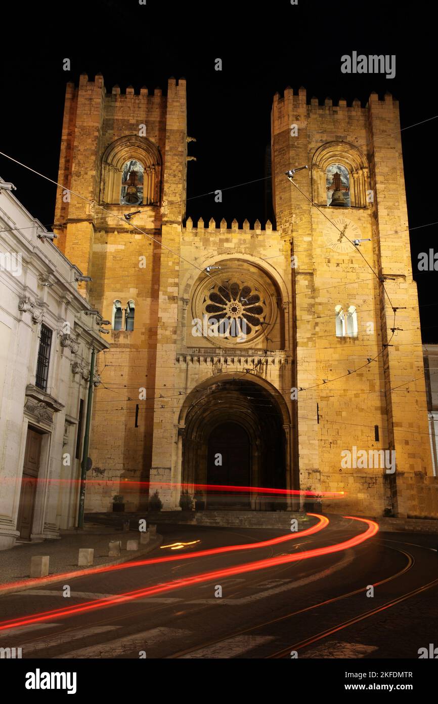 The Se, cathedral in Lisbon night shot with traffic blurs. This Cathedral is one of the famous landmarks in the Portuguese capital city of Lisbon and Stock Photo