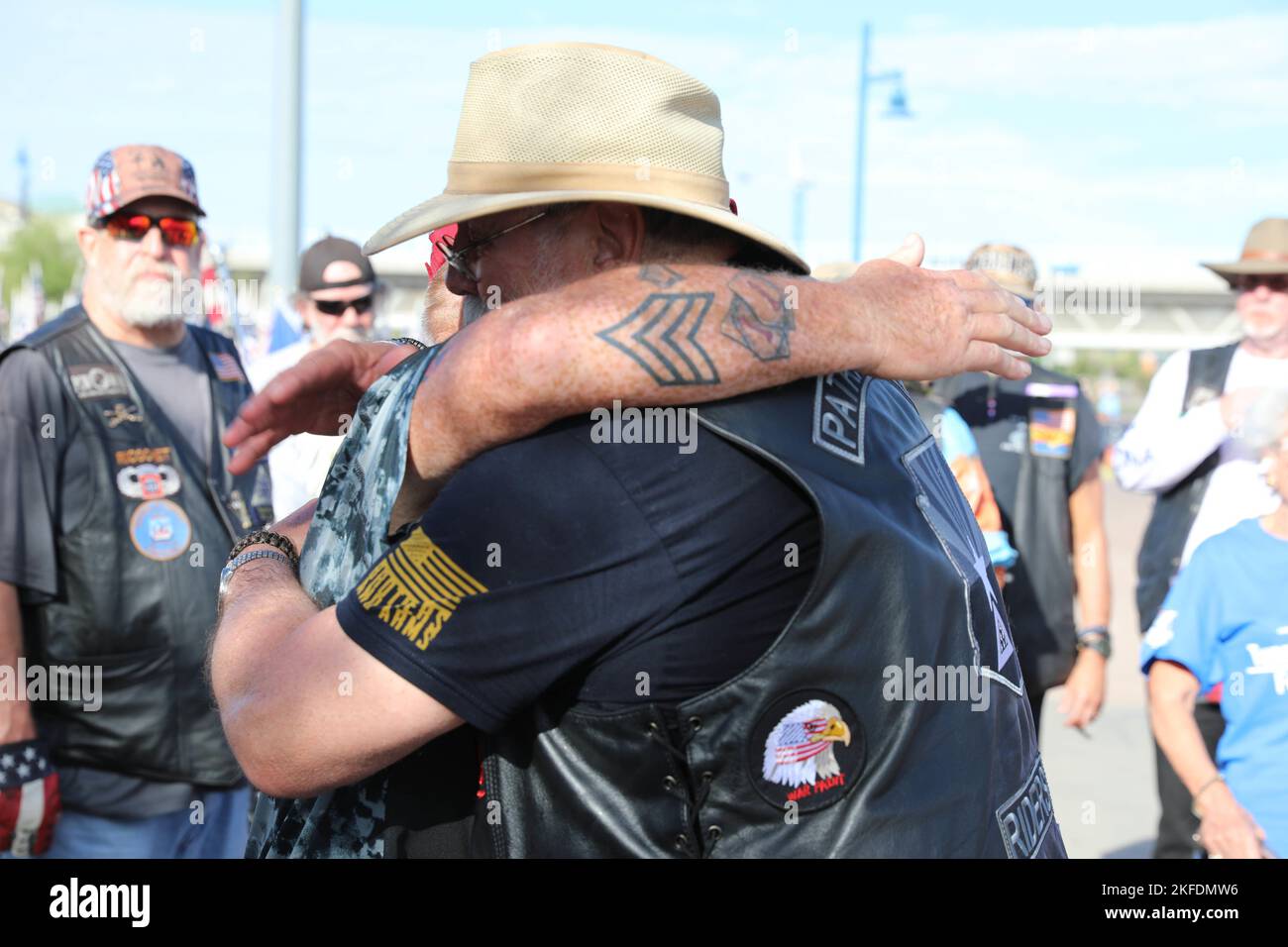 Two members of the Arizona Patriot Guard Riders share a hug during the