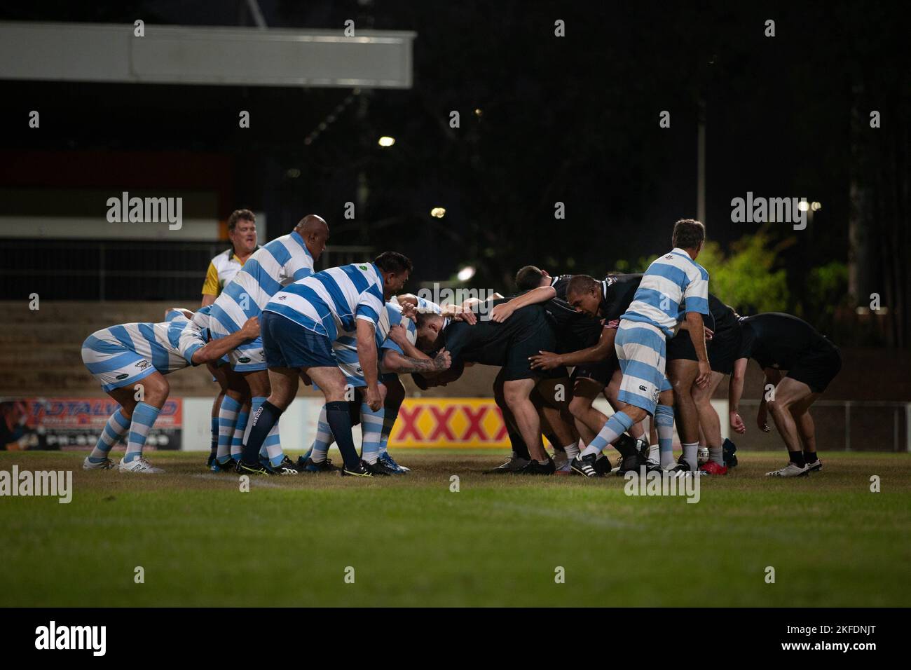 U.S. Marines with Marine Rotational Force-Darwin (MRF-D) 22 and Stray Cats players create a scrummage during a rugby match in Darwin, NT, Australia, Sept. 10, 2022. MRF-D and the Stray Cats held a rugby match as a way to come together and commemorate the events from Sept. 11, 2001. Stock Photo