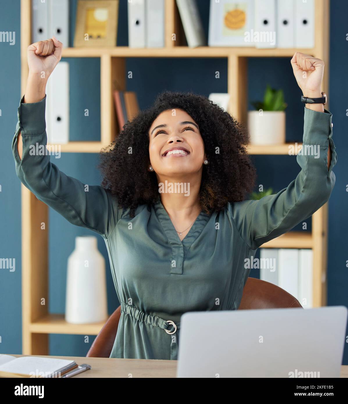 Corporate success, celebration and business woman winning while trading on a laptop at work. Motivation, achievement and employee happy and excited Stock Photo