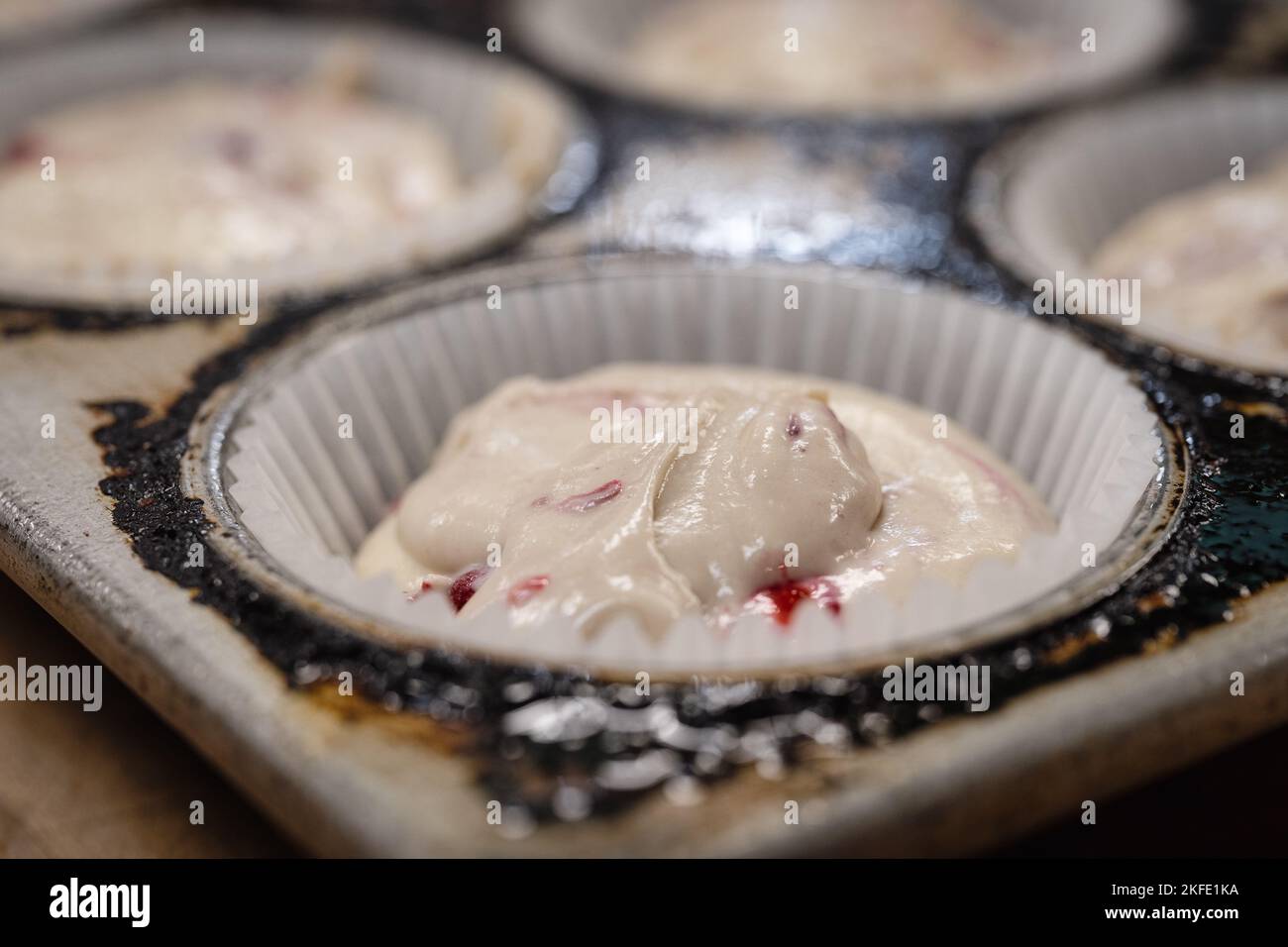 Raw cupcake dough in a baking tin Stock Photo