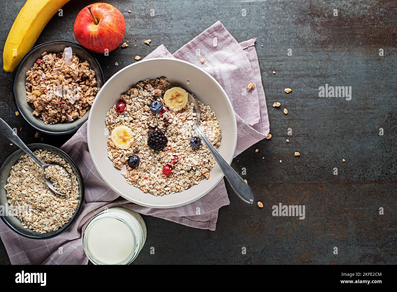 A bowl of dry granola and muesli served with fresh fruit. Oatmeal plate. Healthy food, diet. Top view. Stock Photo