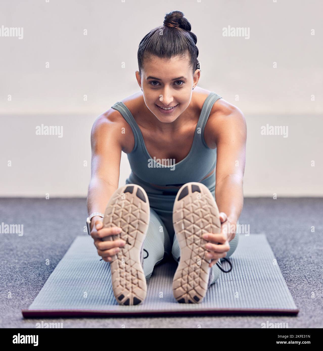 Yoga, fitness and portrait of woman stretching on mat before workout with smile on face. A girl doing pilates, stretch to start training and Stock Photo
