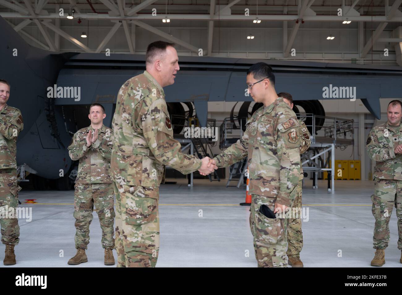 Col. Bryan M. Bailey, commander of the 911th Airlift Wing, coins Senior Airmen Xiaobo Zhang, 911th Security Forces fire team member, at the Pittsburgh International Airport Air Reserve Station, Pennsylvania, Sept. 11, 2022. Zhang was recognized for his outstanding performance in the Exercise STEEL DRAGON readiness inspection. Stock Photo