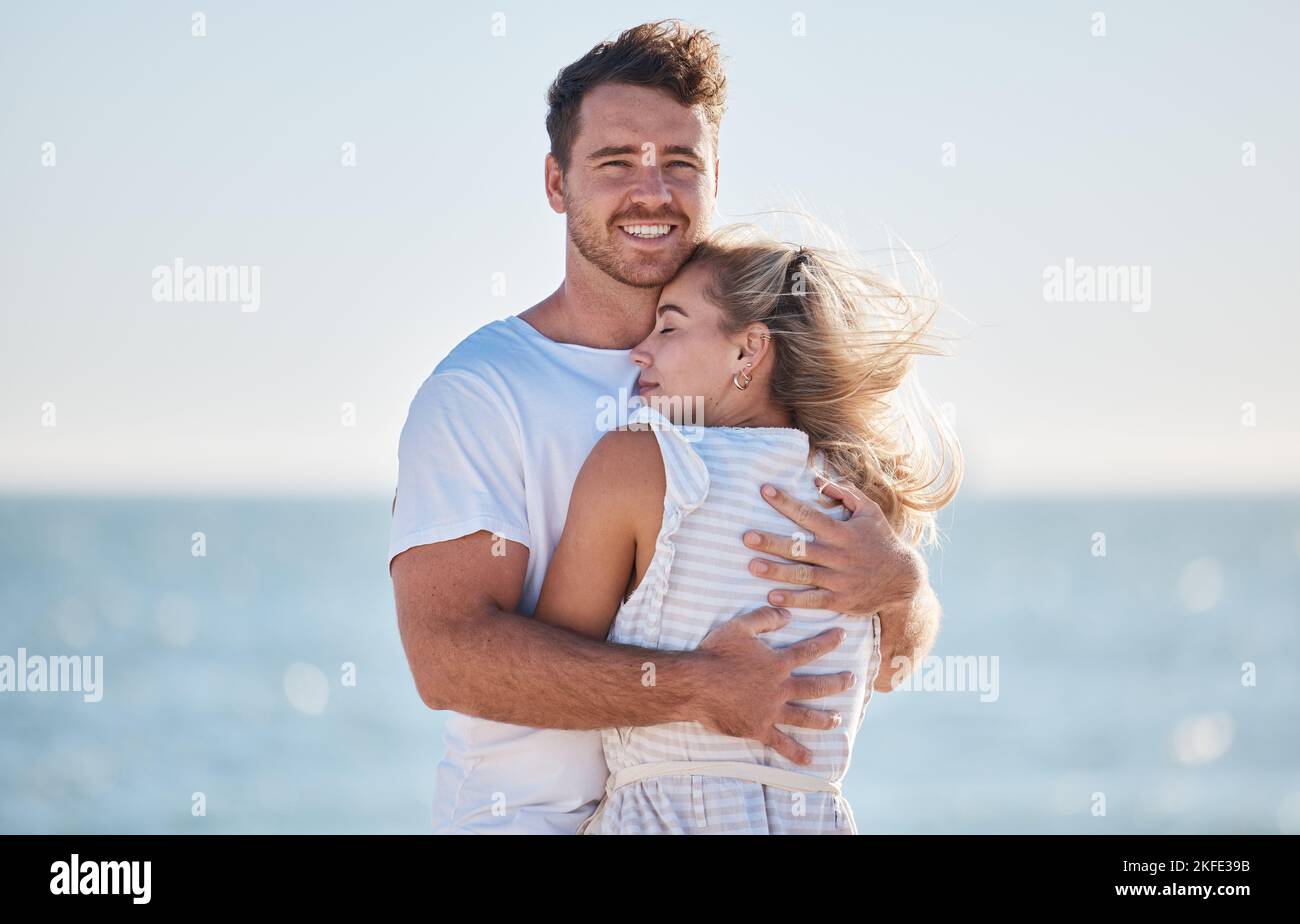 Hug, love and couple at the beach for a date, travel and summer ...