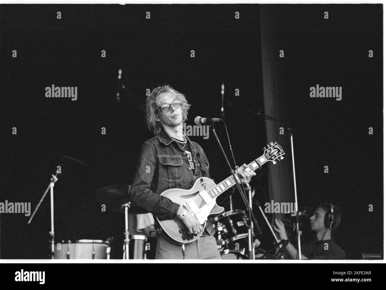 Andy Bell of British indie group Ride playing the Main Stage at Glastonbury, Saturday 25 June 1994. There was no Pyramid Stage that year following a fire. Andy Bell joined Oasis in 1999. Photograph © Rob Watkins Stock Photo