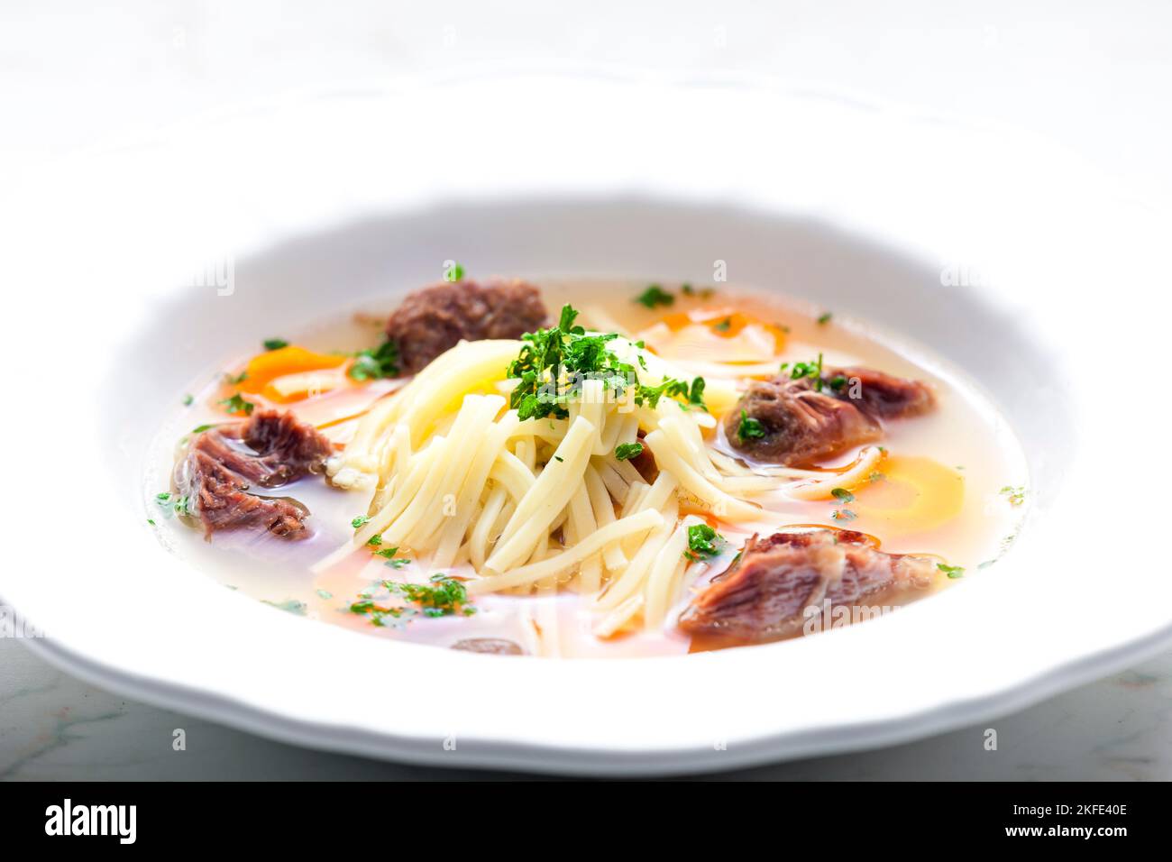 beef broth with noodles and carrot Stock Photo Alamy