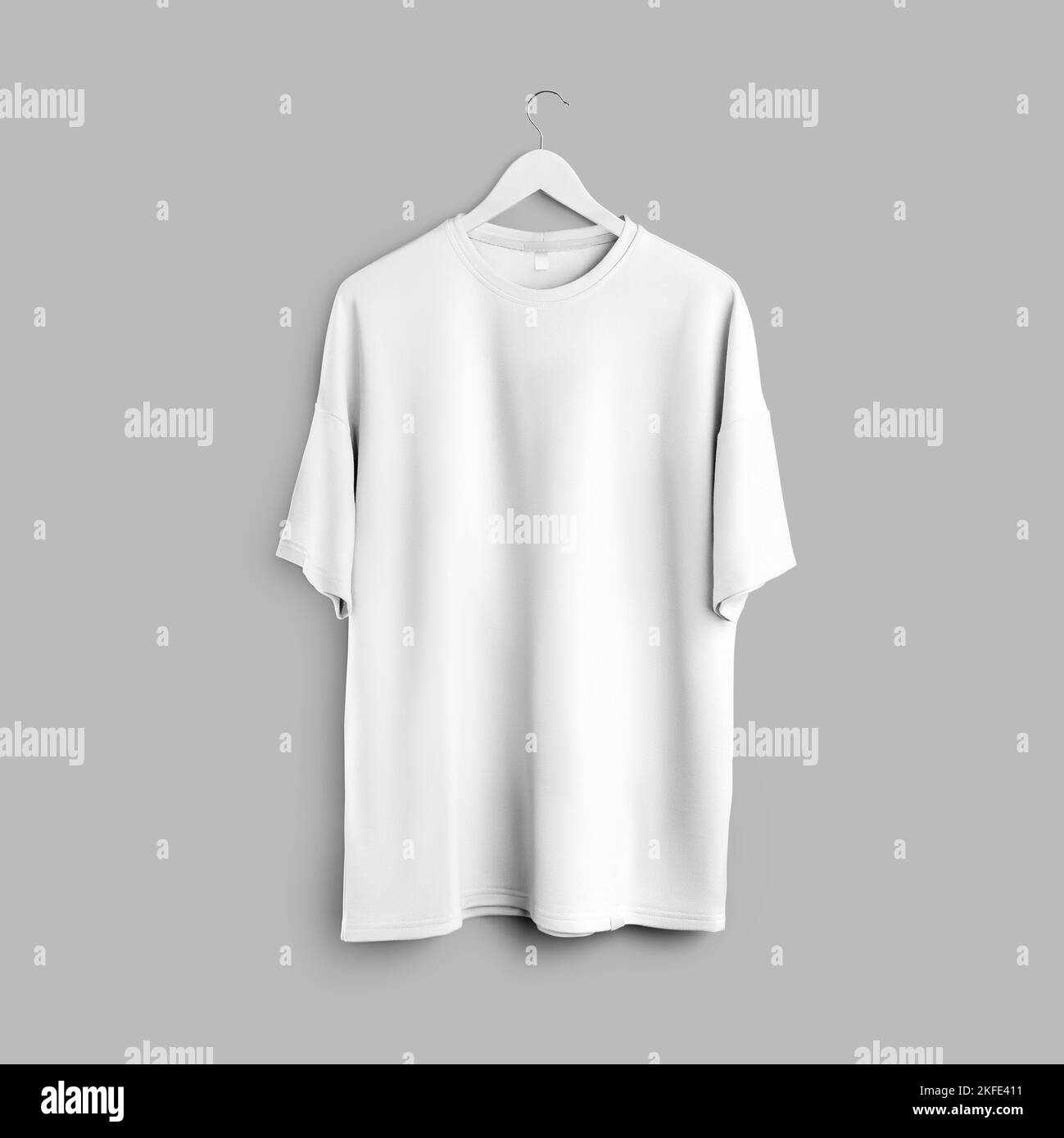 Mockup of white oversized t-shirt with round neckline hanging on hanger isolated on background, front view. Template of stylish apparel for men, women Stock Photo