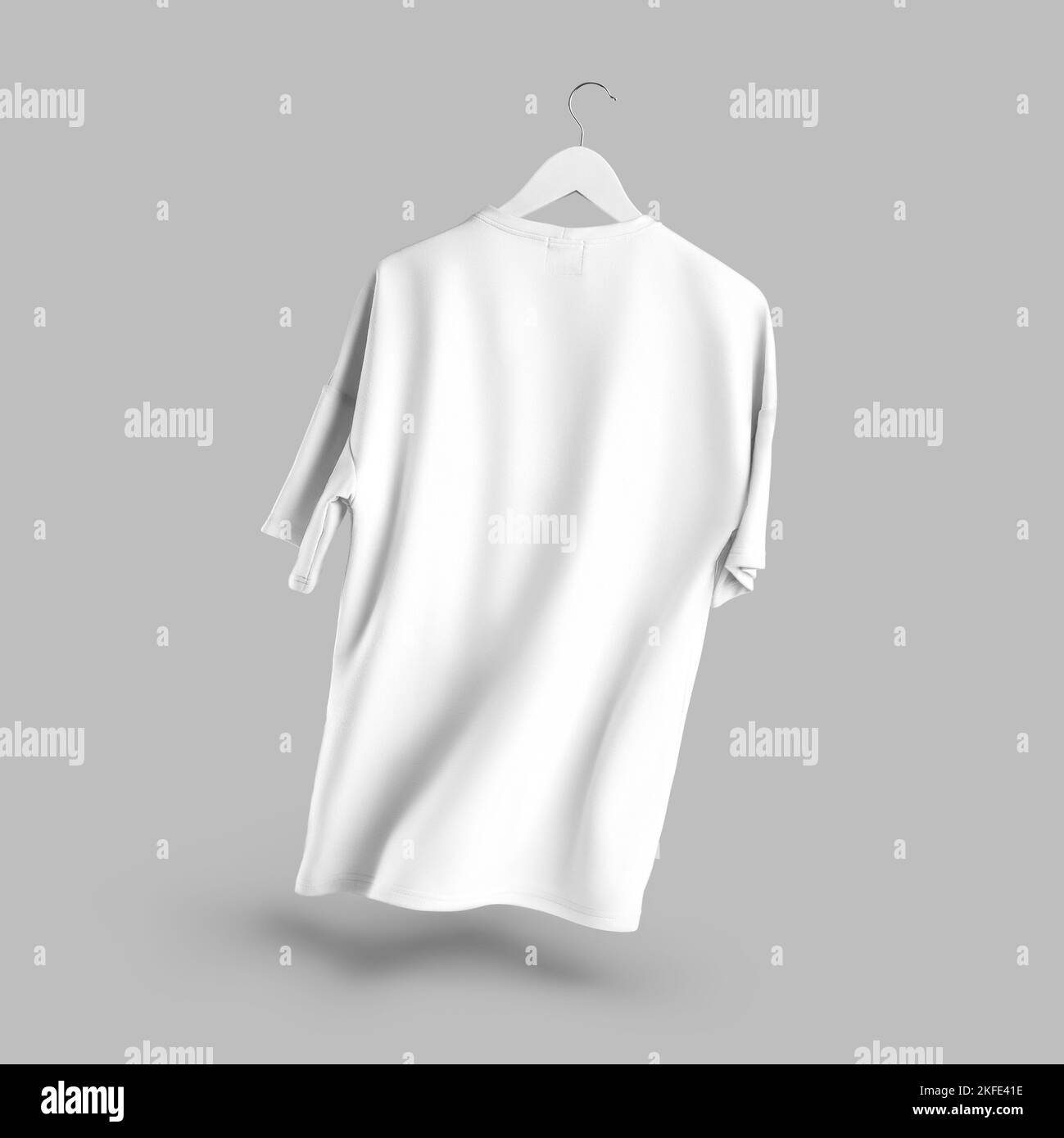 Mockup of an oversized white tshirt hanging on a hanger above a cube