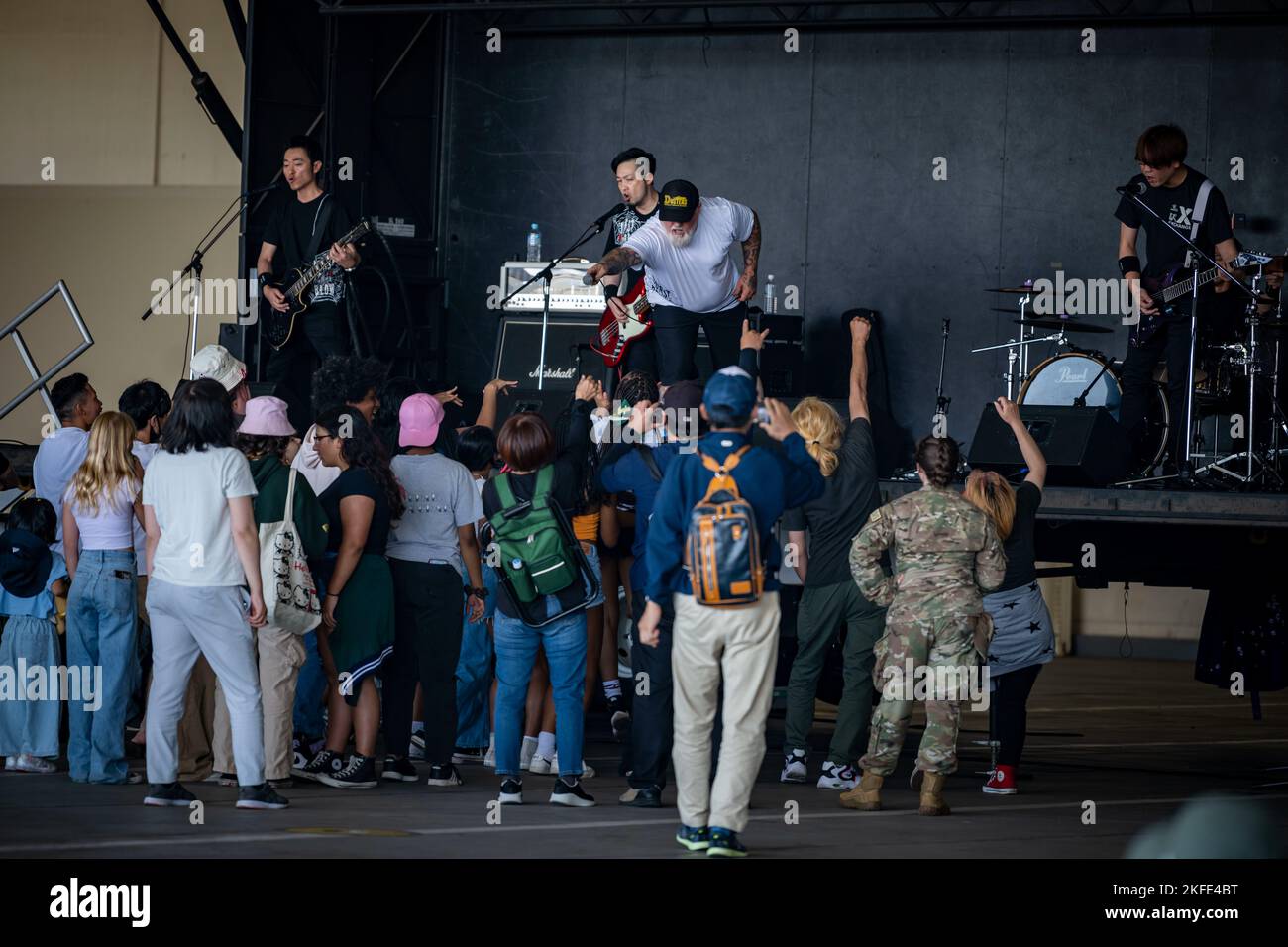 Attendees sing and dance along to a live music band during the misawa
