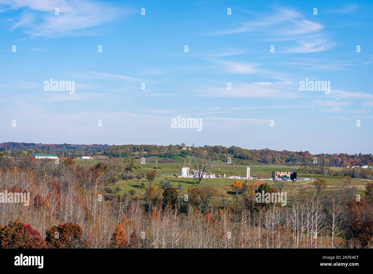 Natural gas oil well pad in Harrison County in eastern Ohio nestled in the autumn countryside. These wells utilize the controversial practice of frack Stock Photo