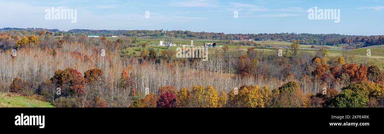 Panoramic landscape containing a natural gas oil well pad in Harrison County in eastern Ohio in autumn These wells utilize the controversial practice Stock Photo