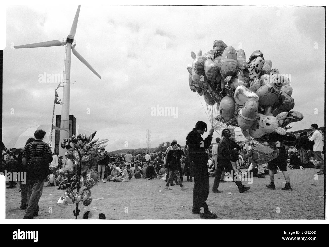 Balloon seller at the Main Stage and field at Glastonbury, 24-26 June 1994. There was no Pyramid Stage that year following a fire. This was also the first year a turbine was erected to supply power to the event. Photograph © Rob Watkins Stock Photo