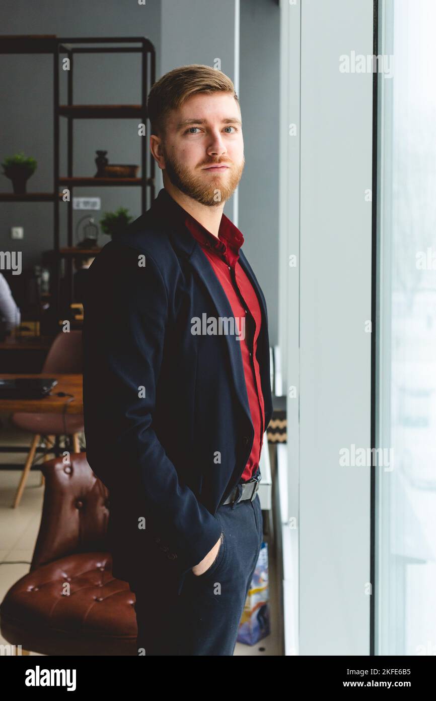 Portrait of a young successful businessman in a suit in the office ...