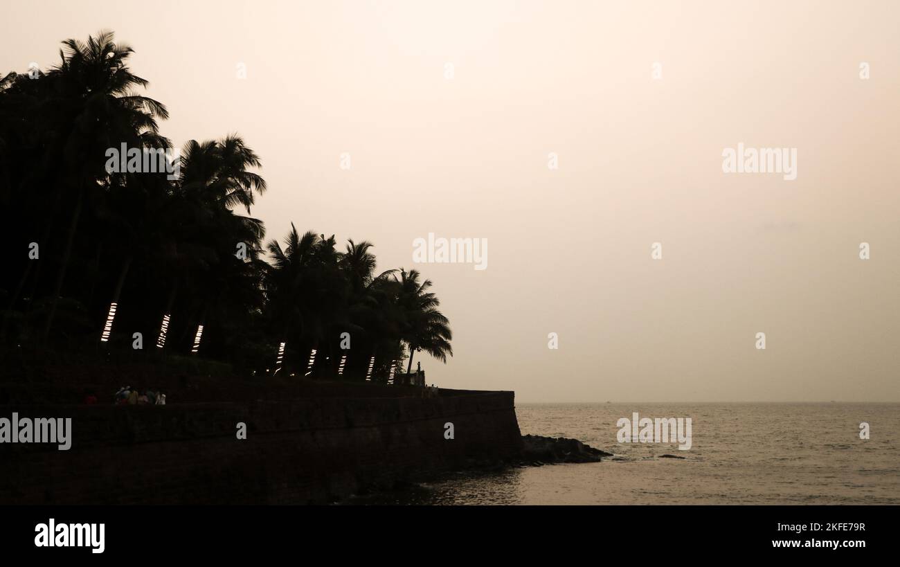 silhouette of the the beach over the sea on a late evening Stock Photo