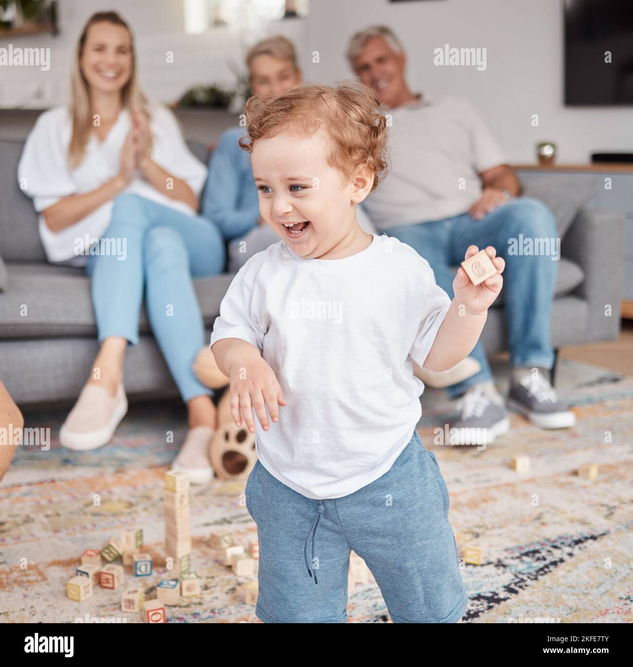Kid, building blocks and happy family in living room home, lounge and house of creative learning, growth and development. Toddler boy child play with Stock Photo