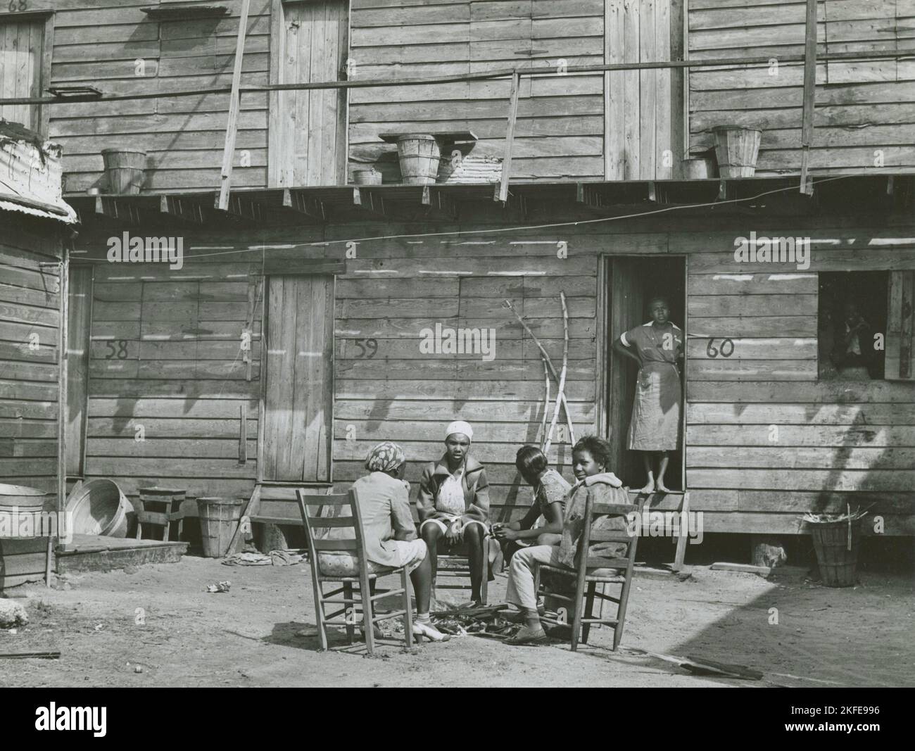 African American woman standing in doorway and African American girls