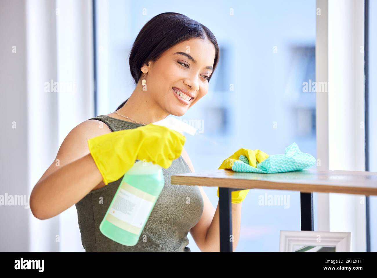 Spray bottle, fabric cloth and cleaner cleaning wooden furniture with