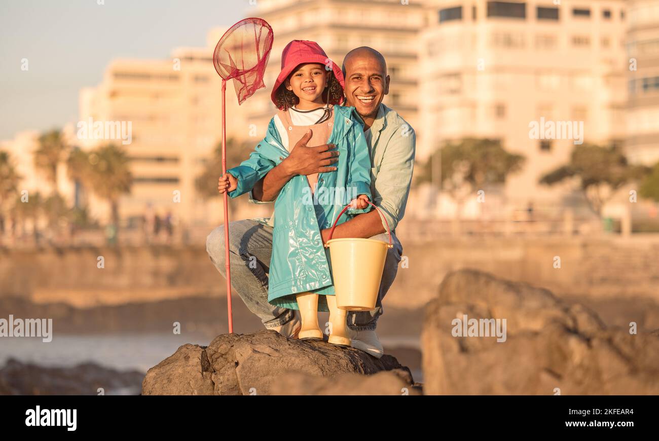 Father, daughter and fishing portrait with a man and child on a ocean holiday for bonding with love. Fish, net and bucket with a dad and girl kid Stock Photo