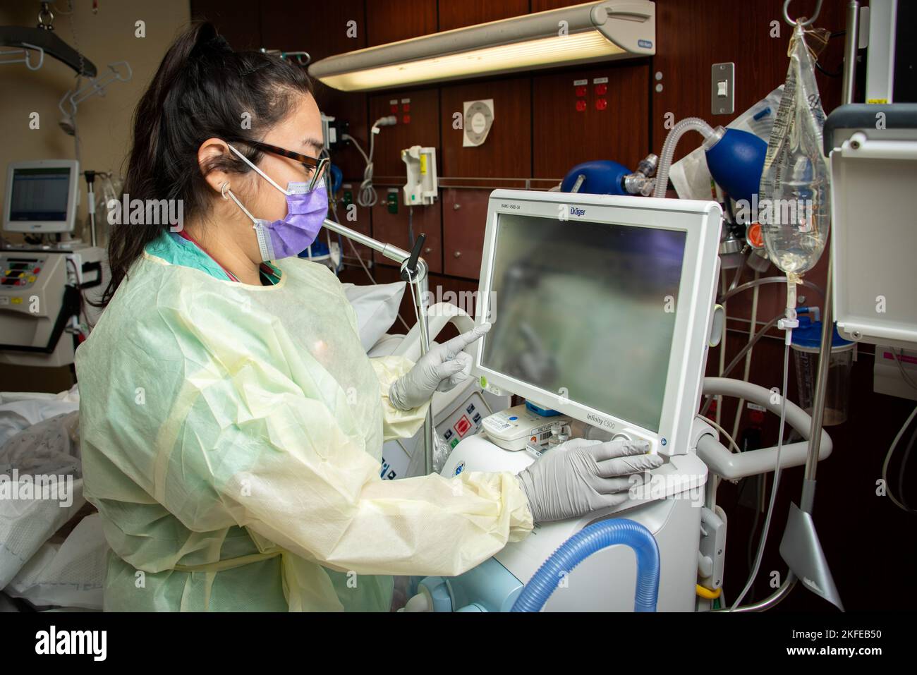 Erika Sanchez, respiratory therapist, checks a ventilator at Brooke