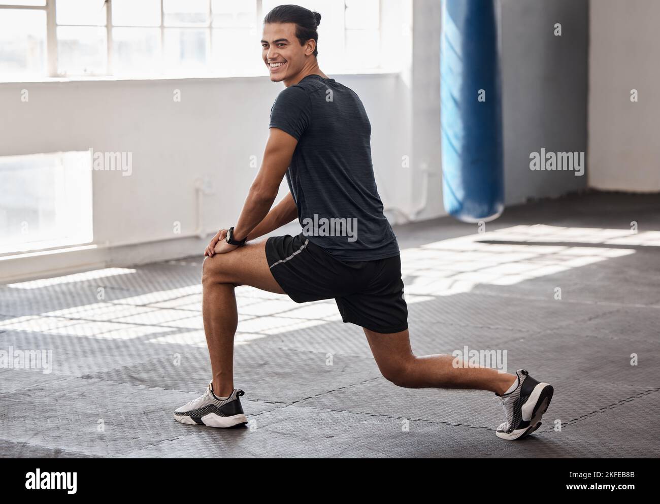 Stretching, fitness and smile with man in gym for training, health and