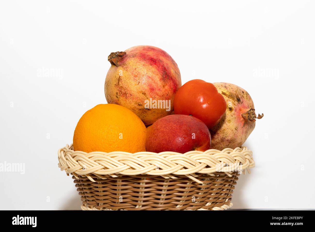 Closeup Image Of Fresh Fruits In Basket In White Background Stock Photo