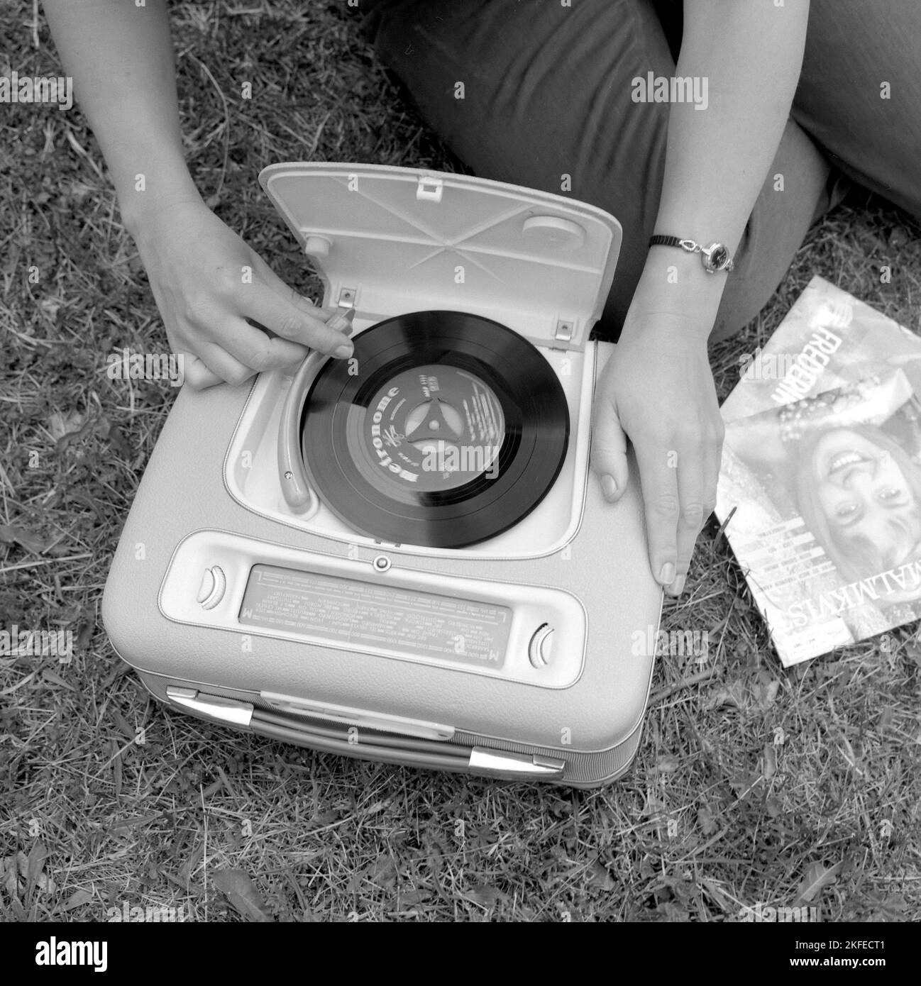 How a combined portable radio and record player looked in the 1960s. A gramophone player as it looked at this time.  This model was battery operated and could play singles,  7 inches 45 rpm vinyl records. You could also listen to the radio on it's radio function, turning the knobs to the frequency and station you wanted to listen to. A practical lid is seen opened and when not using the gramophone you closed it.  Sweden 1960 Conard ref 4264 Stock Photo