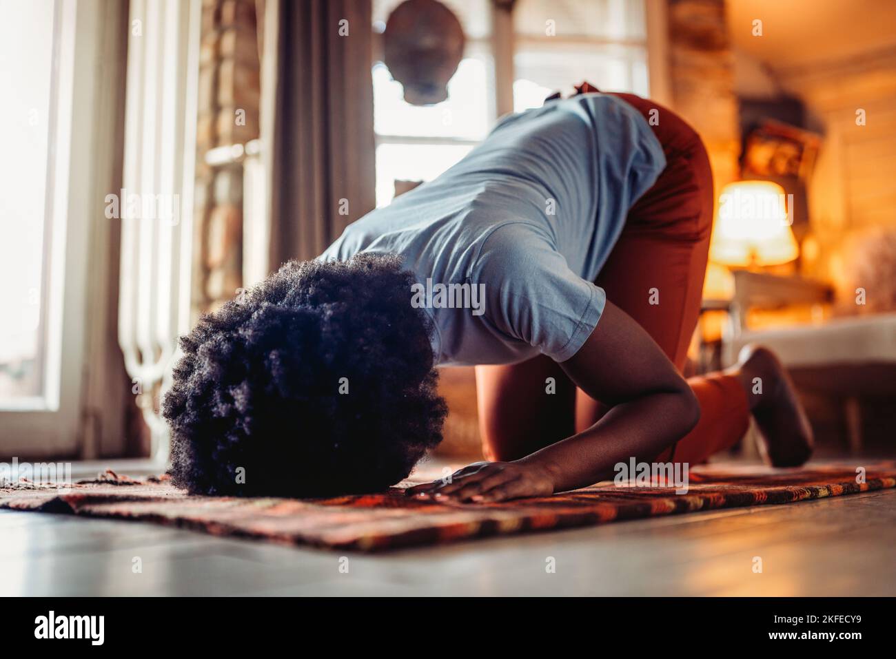 Young muslim black woman praying at home Stock Photo