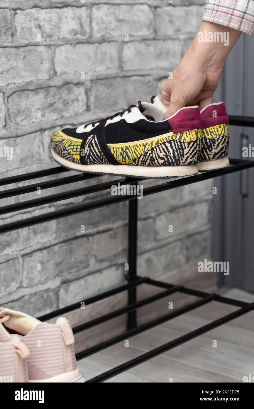 girl puts on sneakers after returning from a walk. man putting on shoes