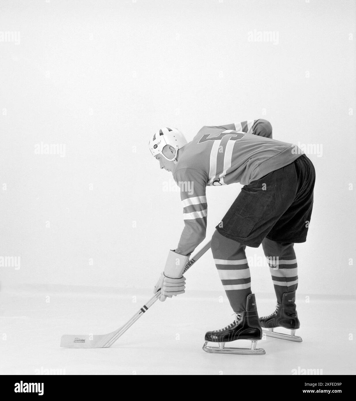 Ice hockey in the 1960s. A young man wearing the decades popular ice