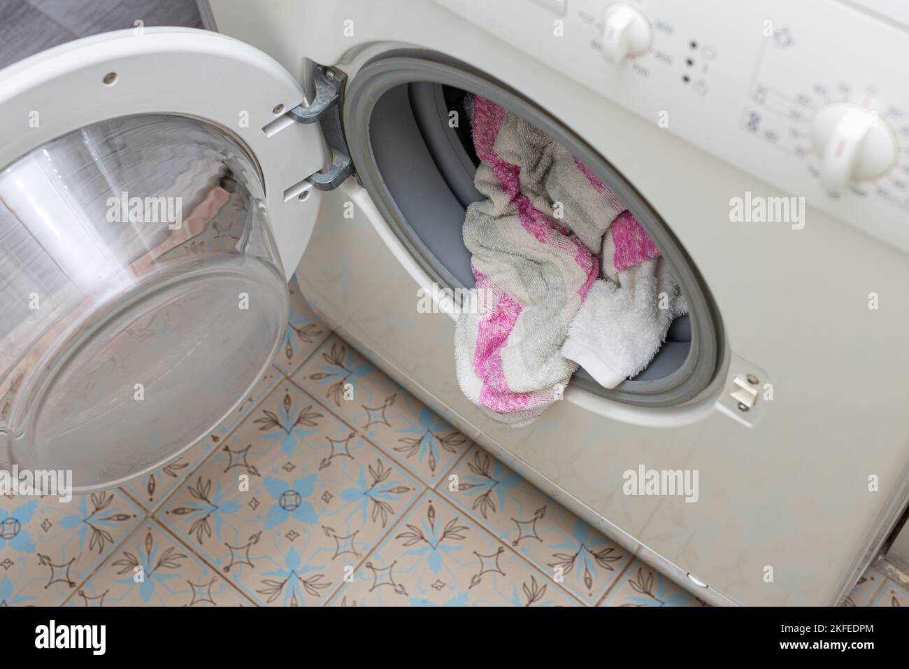 clothes sticking out of the washing machine. clothes after washing. High quality photo Stock