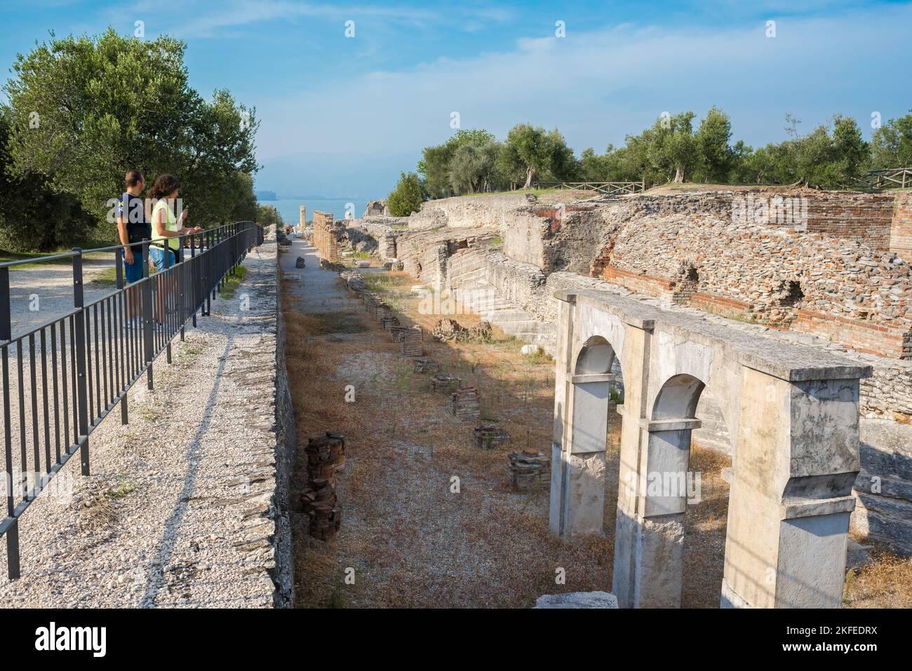 Grotte di Catullo Sirmione, view of people looking at the ruins of an ancient Roman villa believed to be the house of Catullus, Lake Garda, Italy Stock Photo