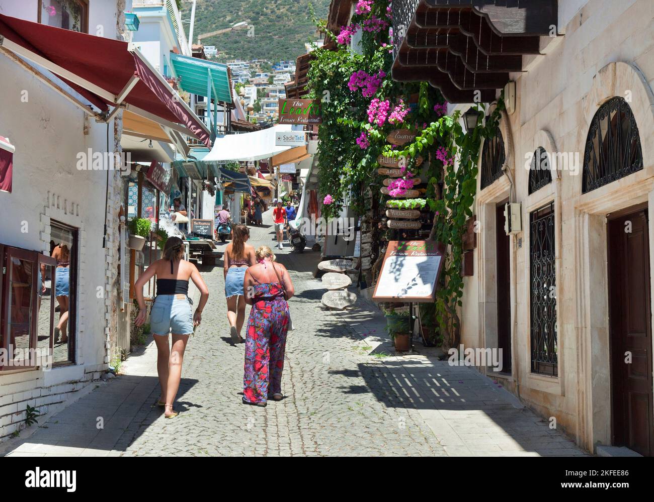 Three British women ( model released ) walk up the steep pretty  streets in Kalkan, Turkey.   August 2022 Stock Photo