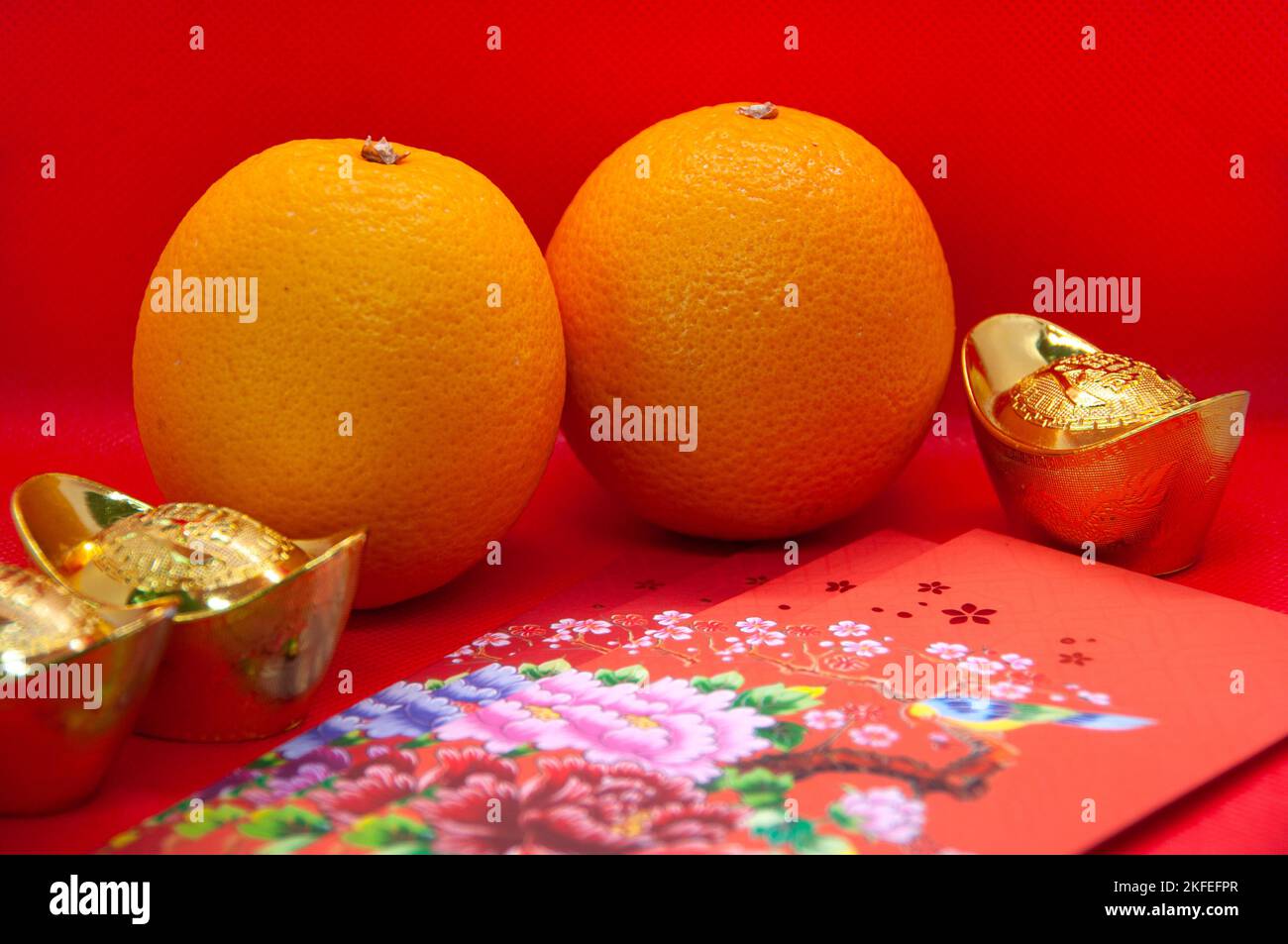 Chinese New Year decoration with oranges, colorful packets and gold