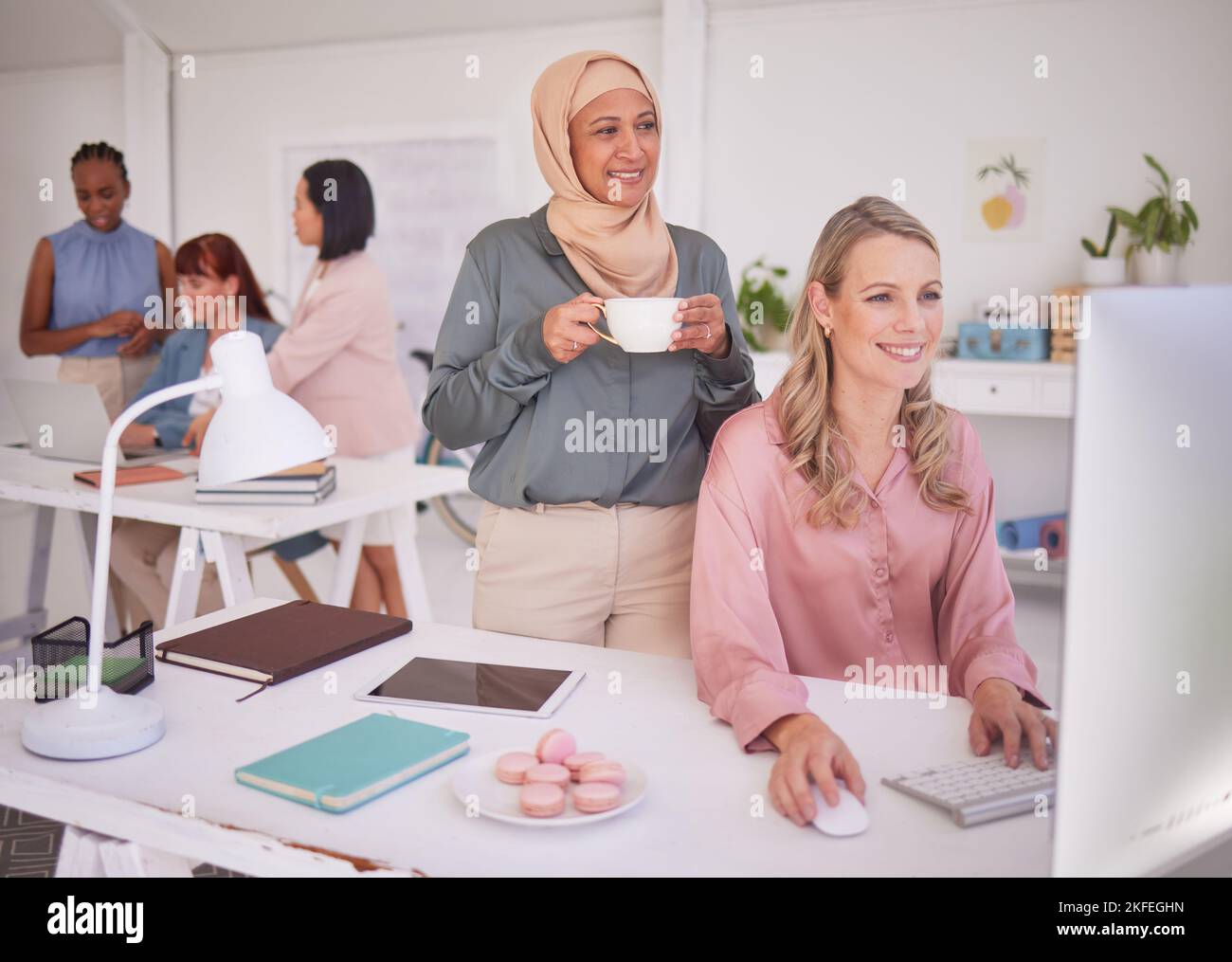Collaboration, computer and marketing with a business woman and muslim partner working in an advertising agency together. Diversity, creative and Stock Photo