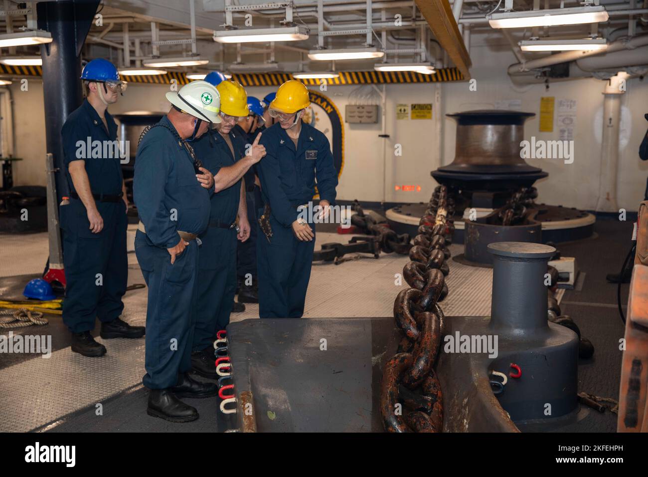 220912-N-VO895-1007  ATLANTIC OCEAN (Sept. 12, 2022) Boatswain’s Mate 2nd Class David Boatright, assigned to the Wasp-class amphibious assault ship USS Bataan (LHD 5) Deck Department, briefs Sailors prior to an anchor drop evolution in the ship’s forecastle, Sept. 12, 2022. Bataan is underway conducting deck landing qualifications as part of the basic phase training cycle. Stock Photo