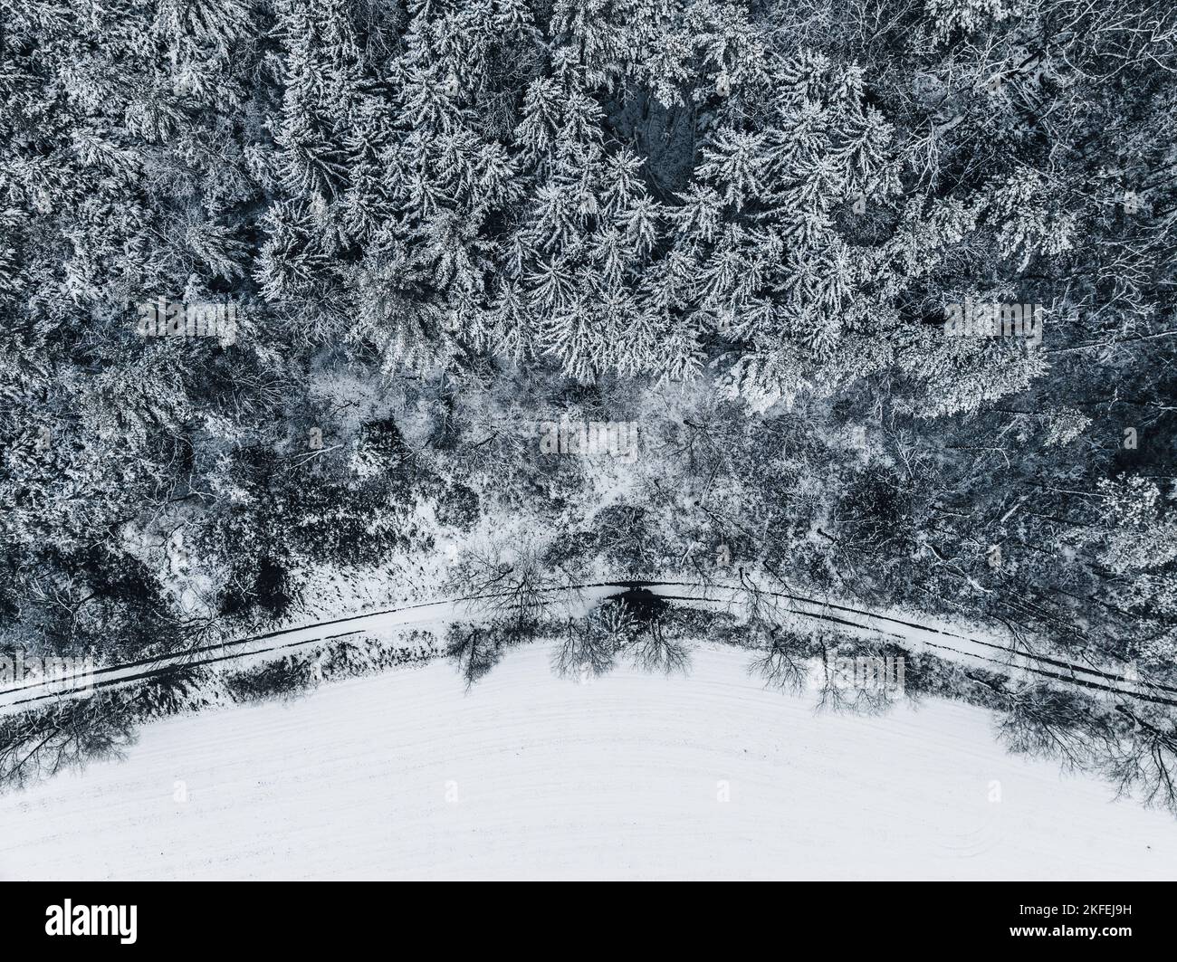 An aerial view of a snowy forest and highway Stock Photo - Alamy