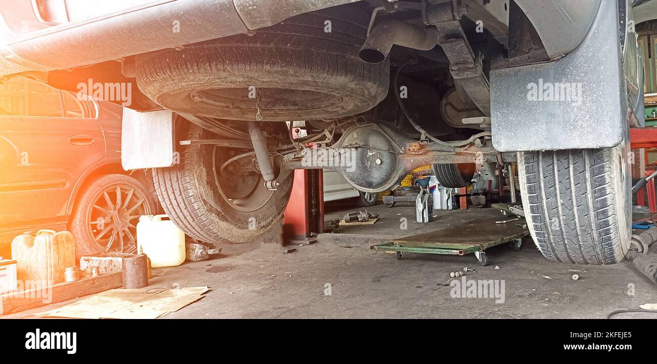 rear of pickup truck that was lifted off the ground to prepare for repair Stock Photo