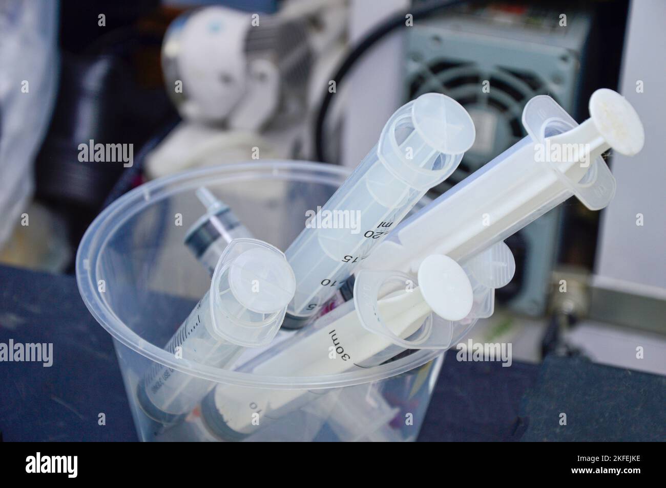 used syringes put in a clear white container Stock Photo Alamy