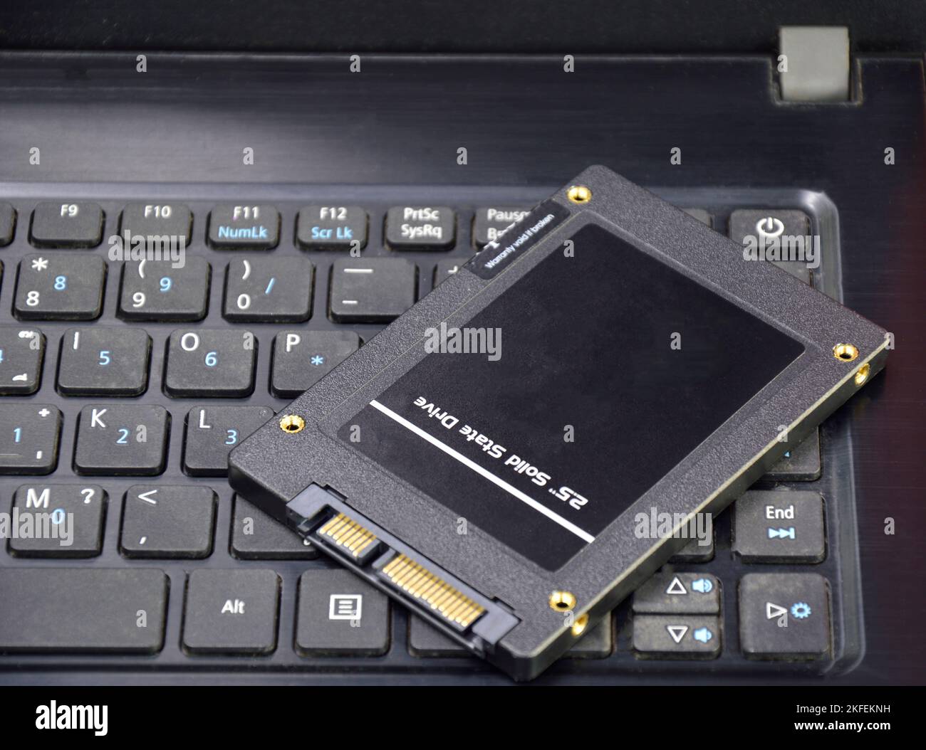 Harddisk SSD 2.5 inch black put on laptop Stock Photo
