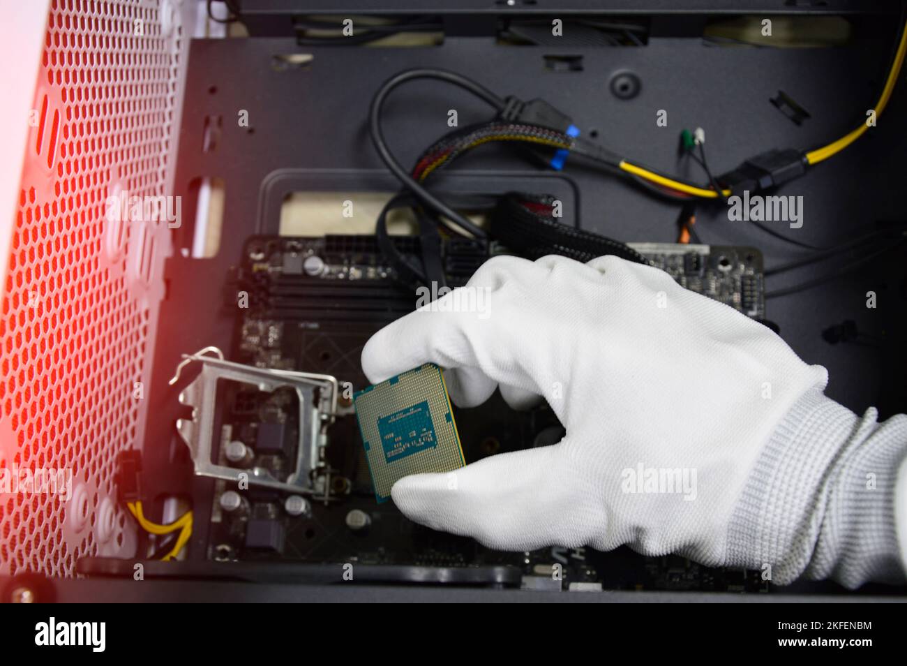 Image of a technician inserting a CPU chip onto a computer motherboard
