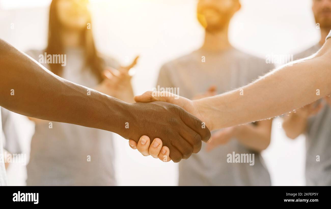 close up. strong handshake of two students of different nationalities ...