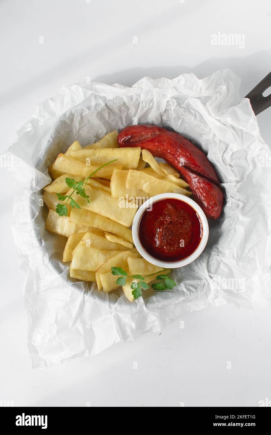 slices of fried yam, sausage and sauce, slices fried yam and stew on ...