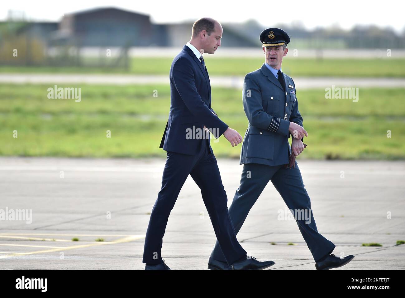 The Prince of Wales walks with Station Commander Billy Cooper during a visit to RAF Coningsby, Lincolnshire, to learn about future technological innovations and open a new boxing club. Picture date: Friday November 18, 2022. Stock Photo