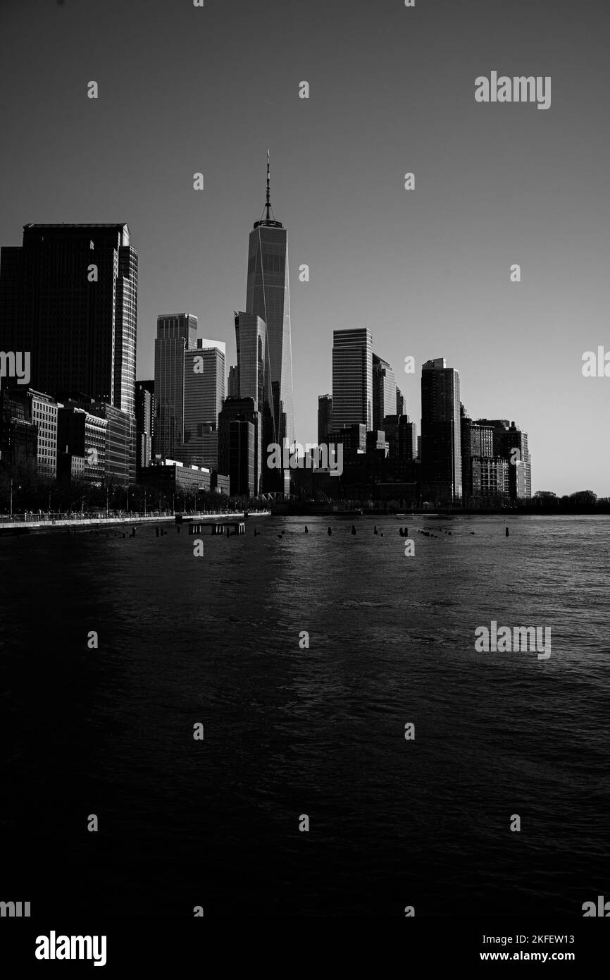 A vertical grayscale of New York City skyscrapers behind the Hudson ...