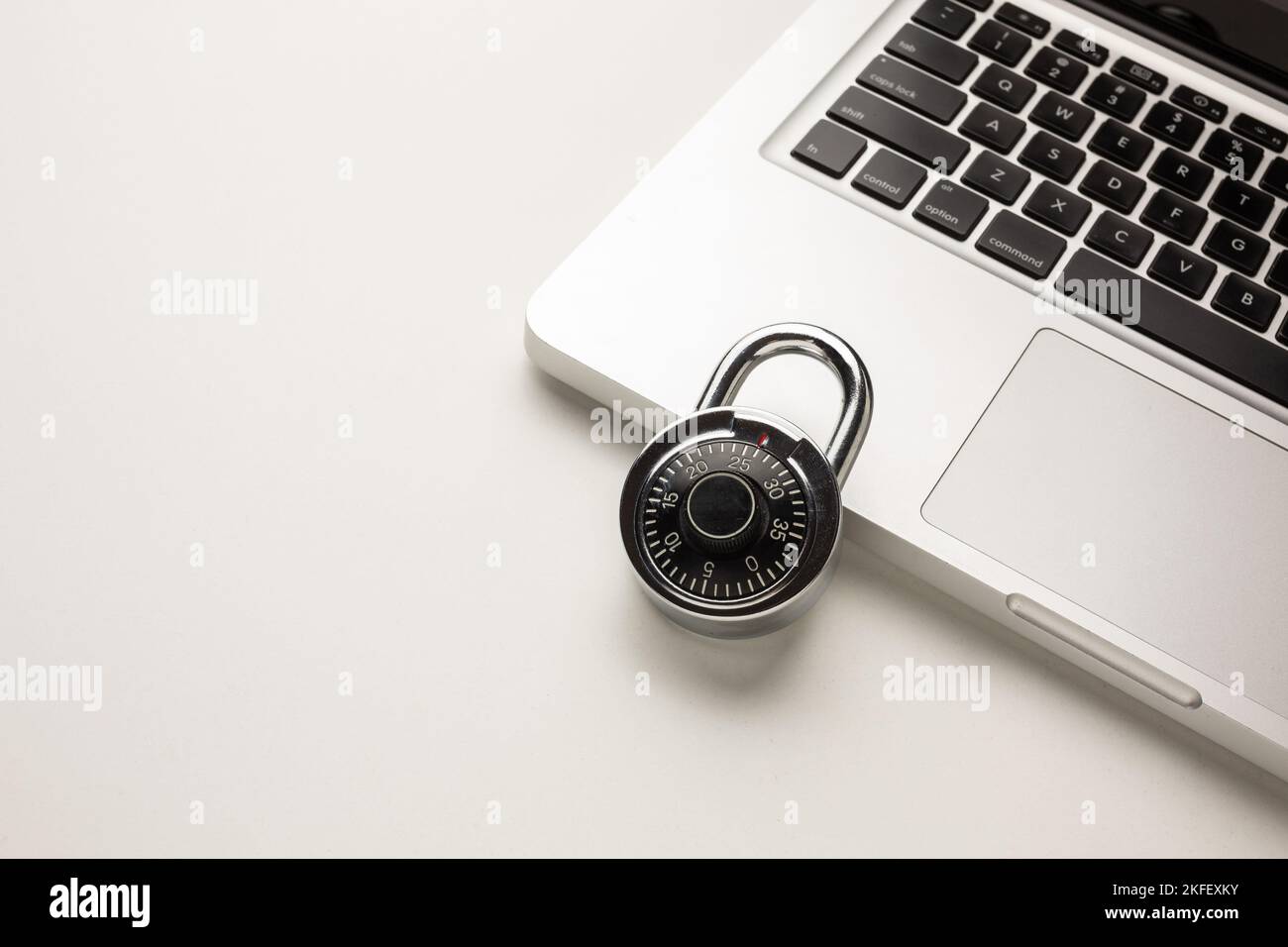 Code-locked padlock on the laptop computer. internet security and Computer security Concept. Stock Photo