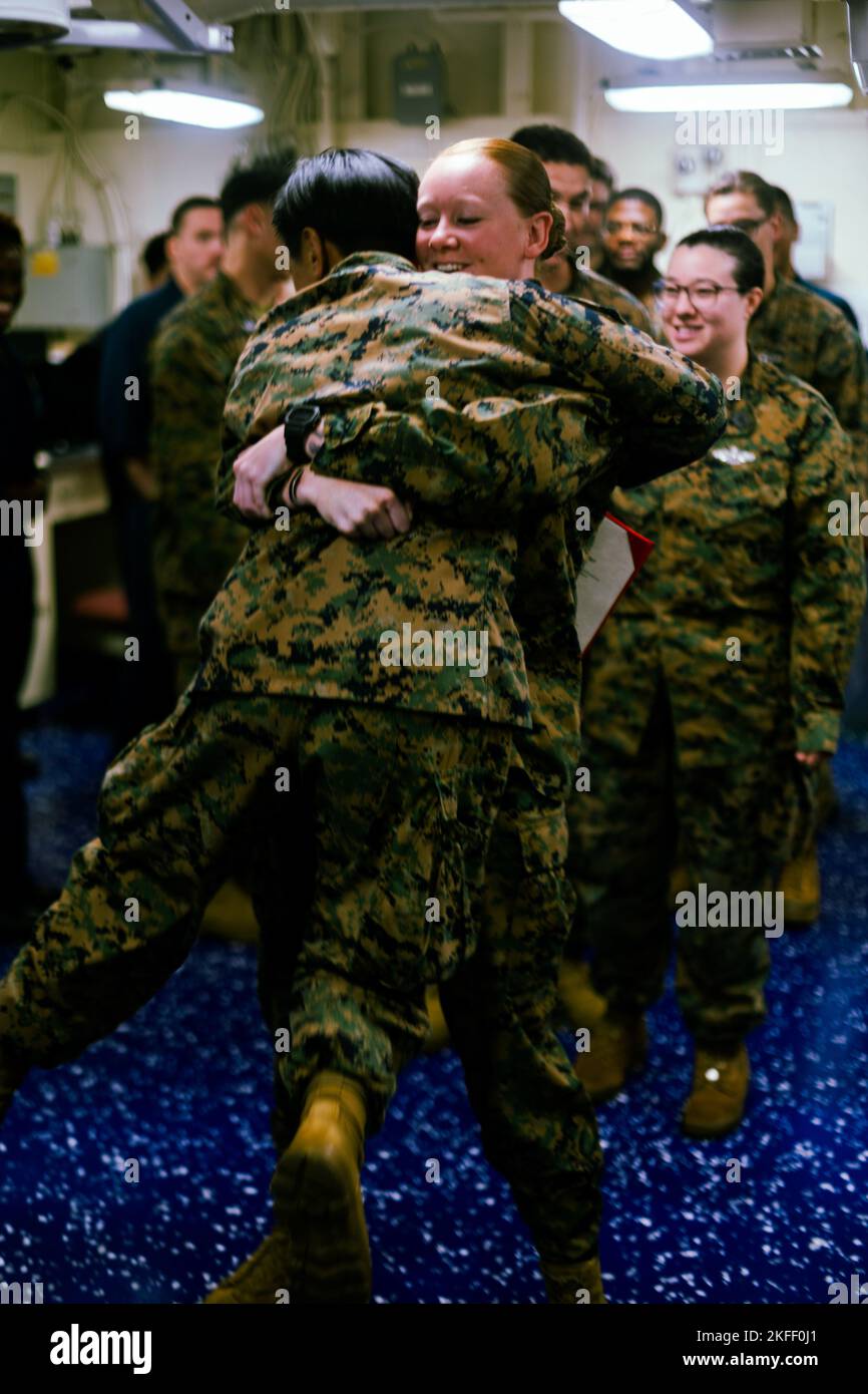 U.S. Navy hospital corpsman 2nd class Hannah Meisberger, with Combat Logistics Battalion 31, 31st Marine Expeditionary Unit, celebrates HOSPITAL CORPSMAN 2ND CLASS Joelle Eusebiodupont, with CLB 31, 31st MEU, on her promotion after the ceremony aboard Amphibious Assault Ship USS Tripoli, in the Philippine Sea, Sept. 13, 2022. The Meritorious Advancement Program recognizes sailors whose performance reflects a rank higher than their current station, and ensures they are allowed to reach their full potential. Stock Photo