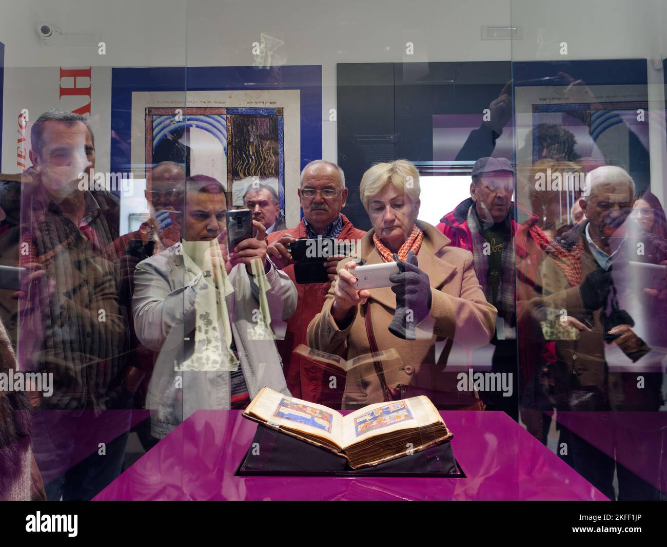People photographing and admiring the original Sarajevo Haggadah, one of the oldest Sephardic Haggadahs in the world. Stock Photo