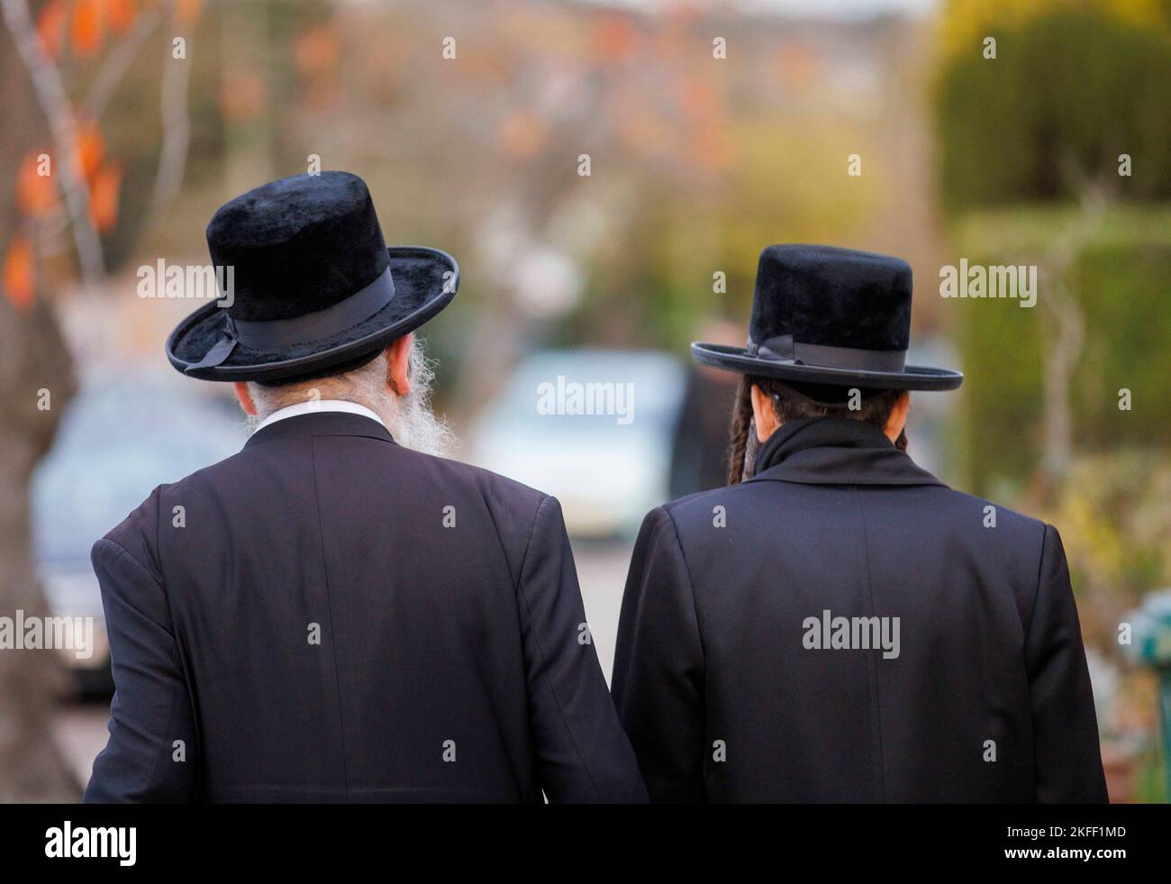 Two Jewish people walk along a road in Golders Green. Judaism is the ethnic religion of the Jewish people who descend from the Israelities and Hebrews. Stock Photo