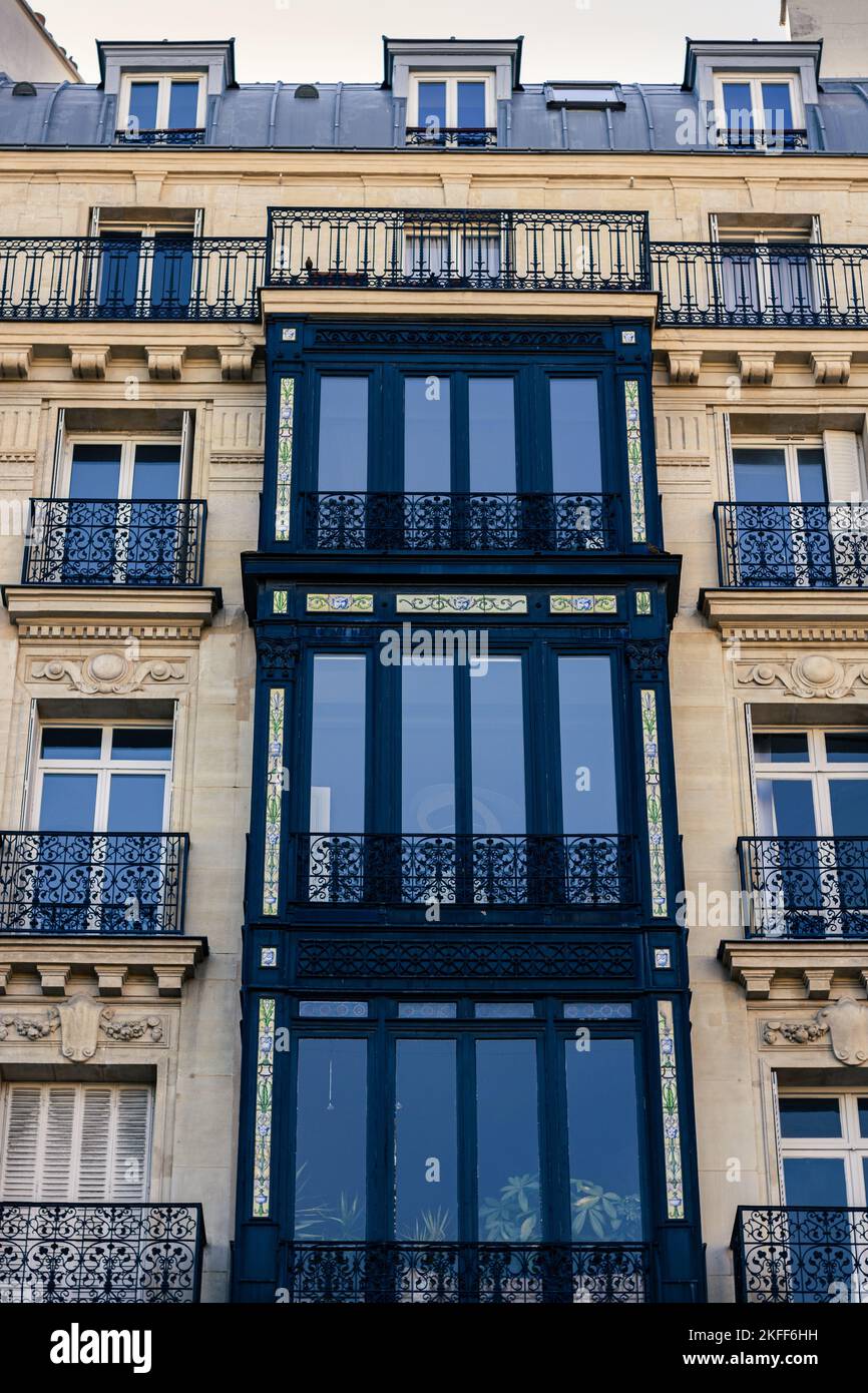 The vertical low-angle shot of a modernized medieval building exterior in Paris Stock Photo